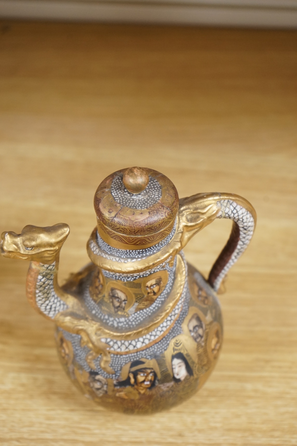 A Japanese Satsuma teapot and cover, signed, 17cm